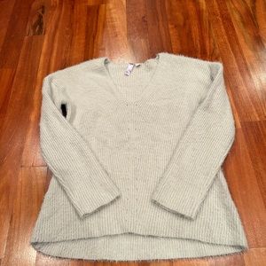 Gray cable knit sweater.